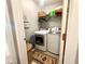 Functional laundry room with a washer, dryer, and shelving, providing convenient space for laundry tasks at 5485 Mountain Top Pl, Cumming, GA 30041