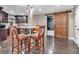 Basement bar area with dark wood cabinetry and a sliding barn door to adjacent room at 850 Highland Bend Cv, Alpharetta, GA 30022