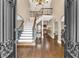 Grand foyer showcasing a sweeping staircase, dark wood floors, and elaborate wrought iron details at 850 Highland Bend Cv, Alpharetta, GA 30022