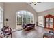 Bright sunroom with tile floors, a large arched window, and comfortable seating at 850 Highland Bend Cv, Alpharetta, GA 30022