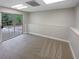 Finished basement space with light gray carpet, recessed lighting, and a glass patio door at 8608 Creekview Ct, Douglasville, GA 30135