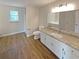Modern bathroom features granite counters, white cabinets, and hardwood floors at 8608 Creekview Ct, Douglasville, GA 30135
