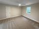 Neutral-toned bedroom featuring carpet, a ceiling fan, and a window providing natural light at 8608 Creekview Ct, Douglasville, GA 30135