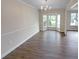 Dining room featuring hardwood floors, a bay window, modern lighting and trim at 8608 Creekview Ct, Douglasville, GA 30135