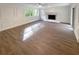 Sun-filled living room featuring hardwood floors, a fireplace, and white trim at 8608 Creekview Ct, Douglasville, GA 30135