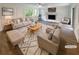 Bright living room featuring hardwood floors, a fireplace, and neutral-toned furniture at 8608 Creekview Ct, Douglasville, GA 30135