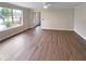 Spacious living room with hardwood floors, a large window, and great natural light at 8608 Creekview Ct, Douglasville, GA 30135