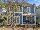 Two-story home with covered front porch, large windows, and professionally landscaped yard at 1338 Dupont Nw Park, Atlanta, GA 30318