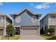 Charming two-story home featuring a pergola over the garage and blue siding at 1338 Dupont Nw Park, Atlanta, GA 30318