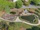 Scenic aerial view of a pond featuring a quaint stone bridge and a stone patio with a fireplace at 1338 Dupont Nw Park, Atlanta, GA 30318