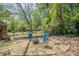 A backyard with a fire pit, seating, and mature trees at 1884 Montrose Dr, East Point, GA 30344