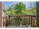 Balcony with brown wooden railing, offering a view of lush greenery at 1884 Montrose Dr, East Point, GA 30344
