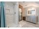 Updated bathroom features marble floors, subway tile in the shower, and exposed brick accent wall at 1884 Montrose Dr, East Point, GA 30344