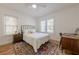 Bright bedroom with hardwood floors, a ceiling fan, and natural light from three windows at 1884 Montrose Dr, East Point, GA 30344