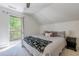 Bedroom featuring a door to the deck with tree views, cozy carpet, and a ceiling fan at 1884 Montrose Dr, East Point, GA 30344