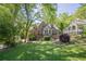 Charming brick home with manicured lawn and lush garden, showcasing its inviting curb appeal and classic design at 1884 Montrose Dr, East Point, GA 30344