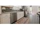 Bright kitchen featuring stainless steel appliances, white cabinetry, and dark backsplash at 1884 Montrose Dr, East Point, GA 30344