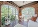 Charming sunroom with exposed brick walls and large windows offering views of the outdoors at 1884 Montrose Dr, East Point, GA 30344