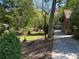 View of the grounds, featuring mature trees and landscaping surrounding the home, creating a private, peaceful outdoor space at 1884 Montrose Dr, East Point, GA 30344
