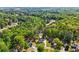 Aerial view showcases the house nestled among lush greenery in a serene neighborhood with mature trees at 1961 Flowering Dr, Grayson, GA 30017