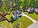 Aerial view of home with a large front yard, mature trees, and a long driveway at 1961 Flowering Dr, Grayson, GA 30017
