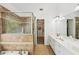 Bright bathroom boasts a walk-in shower, dual sinks, and tile floors at 1961 Flowering Dr, Grayson, GA 30017
