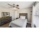 Bright bedroom with wood headboard, ceiling fan, dresser, and ample natural light at 1961 Flowering Dr, Grayson, GA 30017