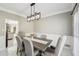 Bright dining room features large windows, modern light fixture and marble flooring at 1961 Flowering Dr, Grayson, GA 30017