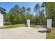 An extended concrete driveway leads to a home with trees in the background at 1961 Flowering Dr, Grayson, GA 30017