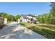 Well-manicured lawn, extended driveway, and a charming backyard deck are features of this home at 1961 Flowering Dr, Grayson, GA 30017