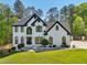 Beautiful two-story home with brick exterior, black trim, landscaped front yard, and mature trees at 1961 Flowering Dr, Grayson, GA 30017