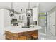 Bright kitchen with white cabinets, quartz counters, an island with wood accents, and modern light fixtures at 1961 Flowering Dr, Grayson, GA 30017