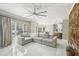 Bright open-concept living room with large sectional, hardwood accent wall and a view of kitchen at 1961 Flowering Dr, Grayson, GA 30017
