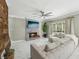 Bright and cozy living room with a fireplace, ceiling fan, and large sectional sofa at 1961 Flowering Dr, Grayson, GA 30017
