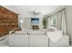 Bright and cozy living room with a fireplace, ceiling fan, and large sectional sofa at 1961 Flowering Dr, Grayson, GA 30017