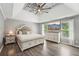 Relaxing main bedroom featuring a tray ceiling, large bed, and ample natural light at 1961 Flowering Dr, Grayson, GA 30017