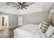 Spacious main bedroom features a decorative ceiling, fan, and wood floors at 1961 Flowering Dr, Grayson, GA 30017