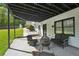 Cozy covered patio with seating, a fire pit, and a view of the landscaped backyard at 1961 Flowering Dr, Grayson, GA 30017