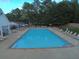 A large community pool surrounded by lounge chairs for relaxing by the water at 1961 Flowering Dr, Grayson, GA 30017