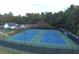 Overhead view of blue community tennis courts surrounded by trees at 1961 Flowering Dr, Grayson, GA 30017