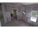 Living room view with rough drywall, unfinished floors and door leading to other rooms at 3689 Ashwood Se Dr, Smyrna, GA 30080