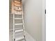 Hall access to attic featuring a drop down ladder with white shelving nearby at 1183 Woods Ne Cir, Atlanta, GA 30324