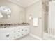 Modern bathroom with double vanity, granite counters, and a tub-shower combo at 1183 Woods Ne Cir, Atlanta, GA 30324