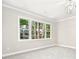 Bright bedroom with a large window overlooking lush trees at 1183 Woods Ne Cir, Atlanta, GA 30324