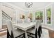 Bright dining room with views, a contemporary table, stylish chairs, and an elegant chandelier fixture at 1183 Woods Ne Cir, Atlanta, GA 30324