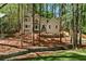 Charming exterior view of a two-story home surrounded by mature trees and beautiful landscaping at 1183 Woods Ne Cir, Atlanta, GA 30324