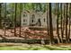 Beautiful two-story home with a well-manicured lawn, nestled amongst mature trees and lush greenery at 1183 Woods Ne Cir, Atlanta, GA 30324