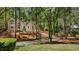Beautiful home with a winding driveway, nestled amongst mature trees on a lush, green lawn at 1183 Woods Ne Cir, Atlanta, GA 30324