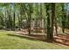Lush, green yard leads to the home exterior surrounded by mature trees, providing privacy and natural beauty at 1183 Woods Ne Cir, Atlanta, GA 30324
