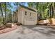 Exterior view of a home with a spacious garage, featuring an access driveway and tasteful landscaping at 1183 Woods Ne Cir, Atlanta, GA 30324